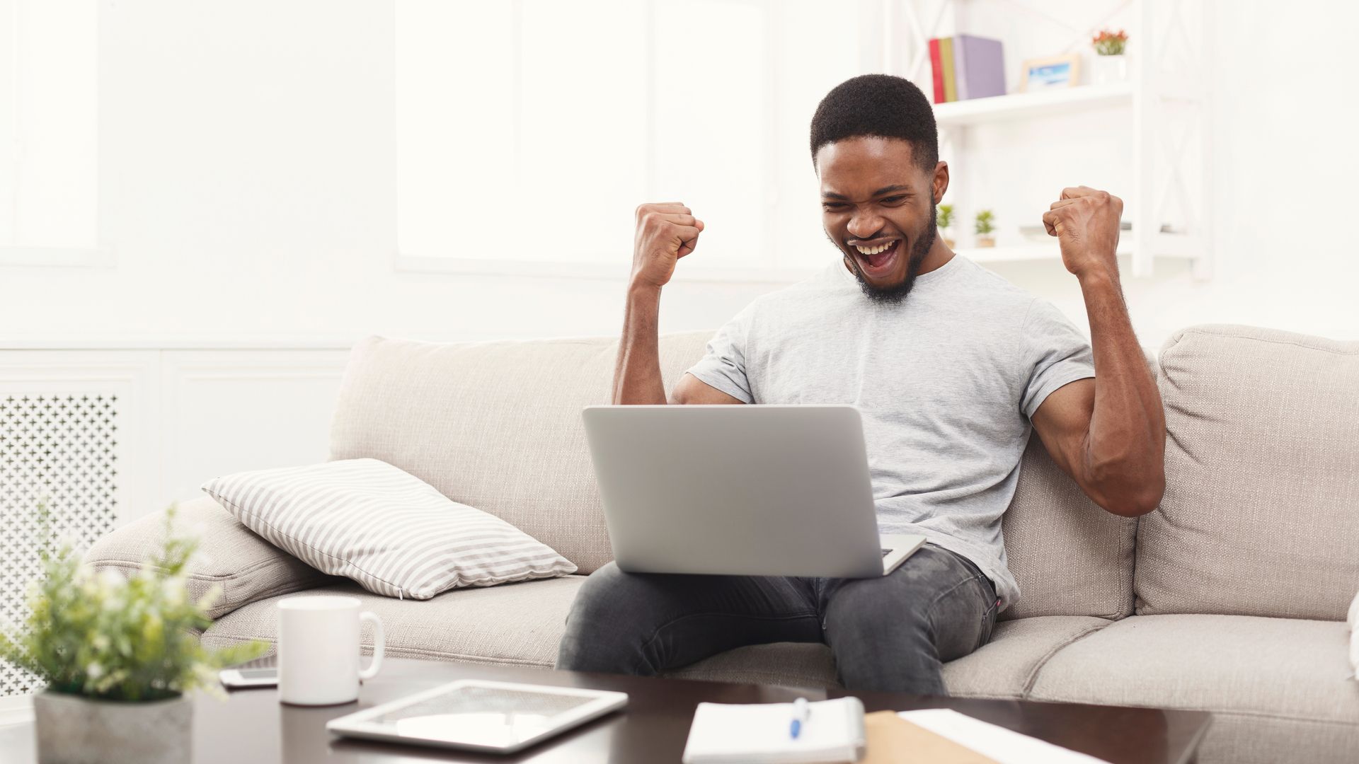 Happy man with Windows 11 laptop on his lap