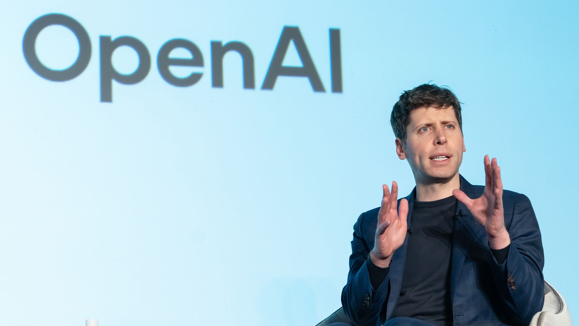 OpenAI CEO Sam Altman pictured speaking with SoftBank Group CEO Masayoshi Son at an event titled "Transforming Business through AI" in Tokyo, Japan.